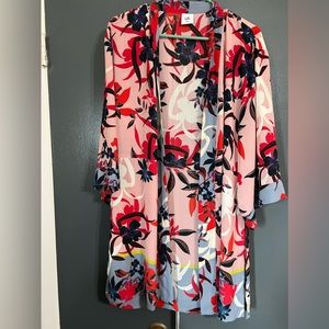 the brand is Cabi, the size is XS/S the base is pink with blue and red flowers